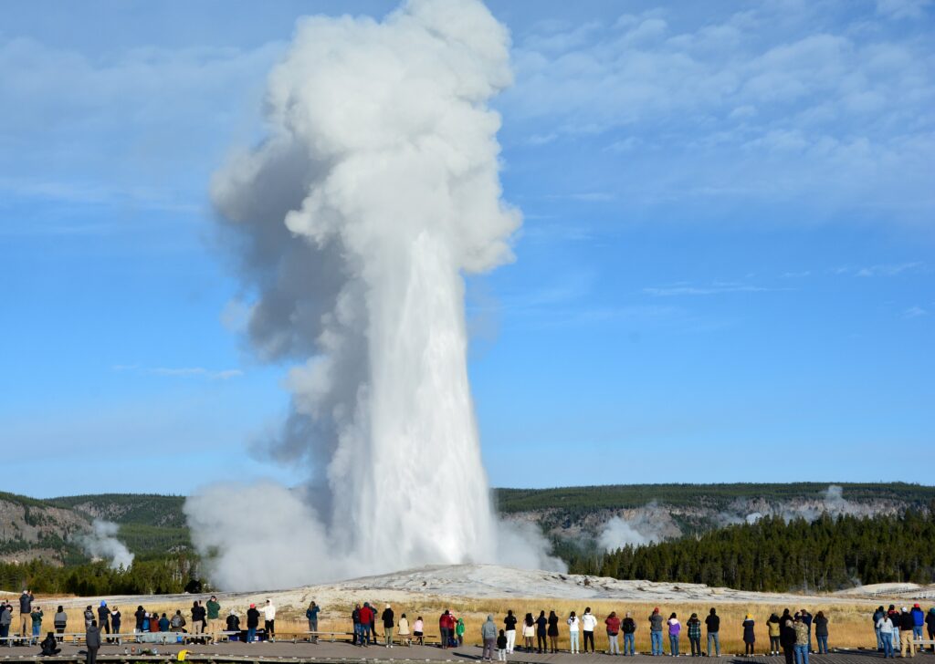 Az Old Faithful gejzír Yellowstone Nemzeti Parkban, Wyoming államban, egy hatalmas víz- és gőzkifújással, amely az ég felé emelkedik